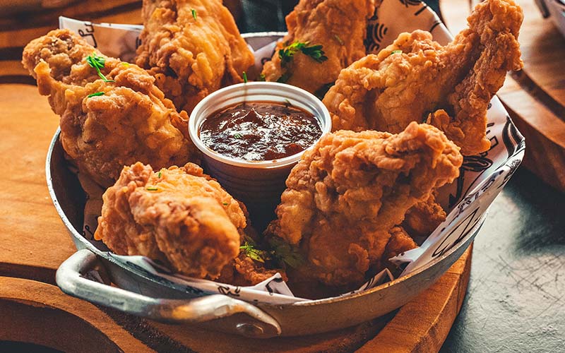 Image: A plate of Southern Fried Chicken served with sides, showcasing its golden crispiness and savory aroma. Discover the allure of Southern Fried Chicken in Dubai - a tantalizing option among the city's diverse culinary offerings.