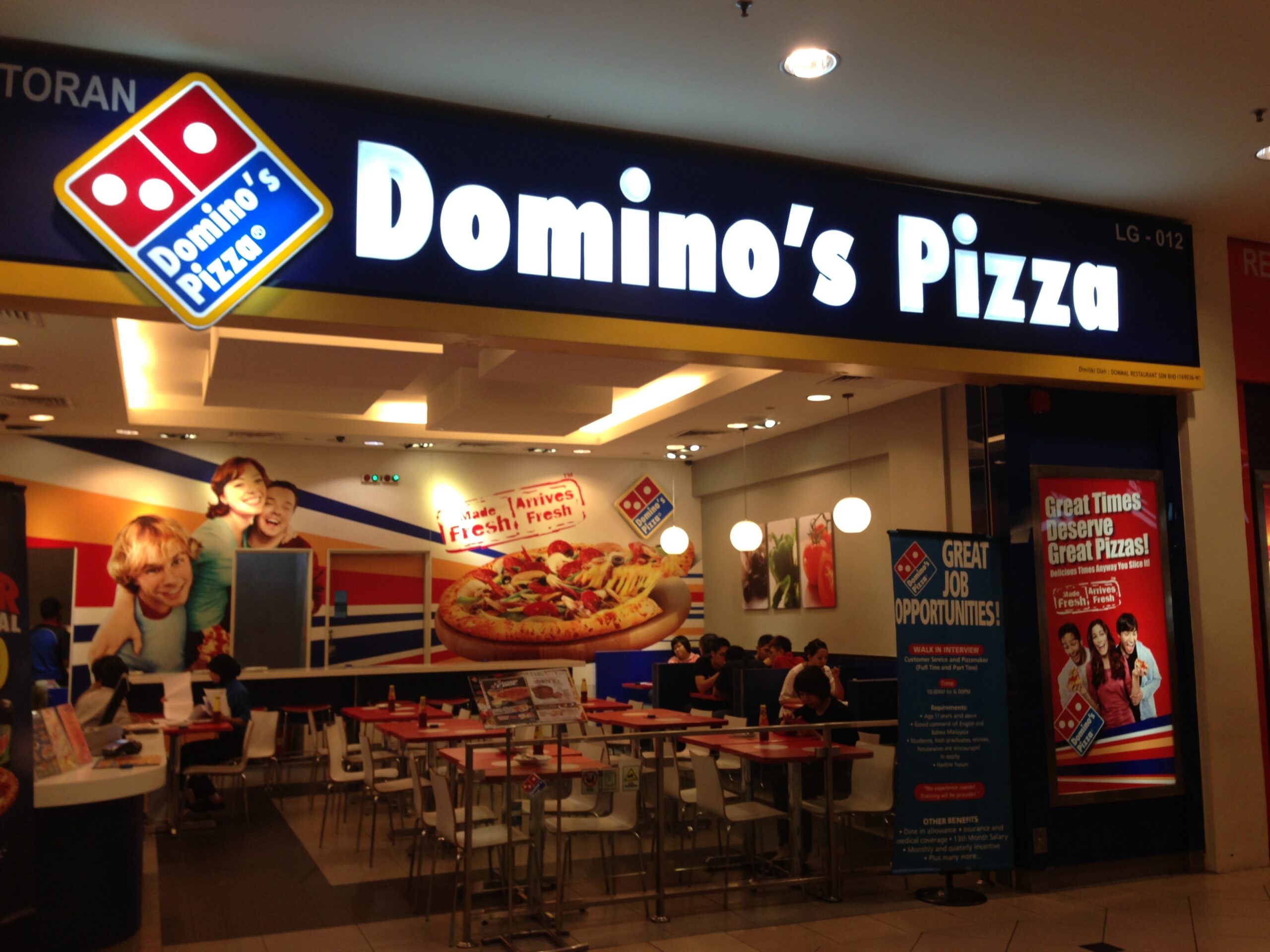 Image: Domino's Pizza logo featuring two blue domino tiles with the brand name in red font. Top pizza franchise in India - Domino's Pizza.